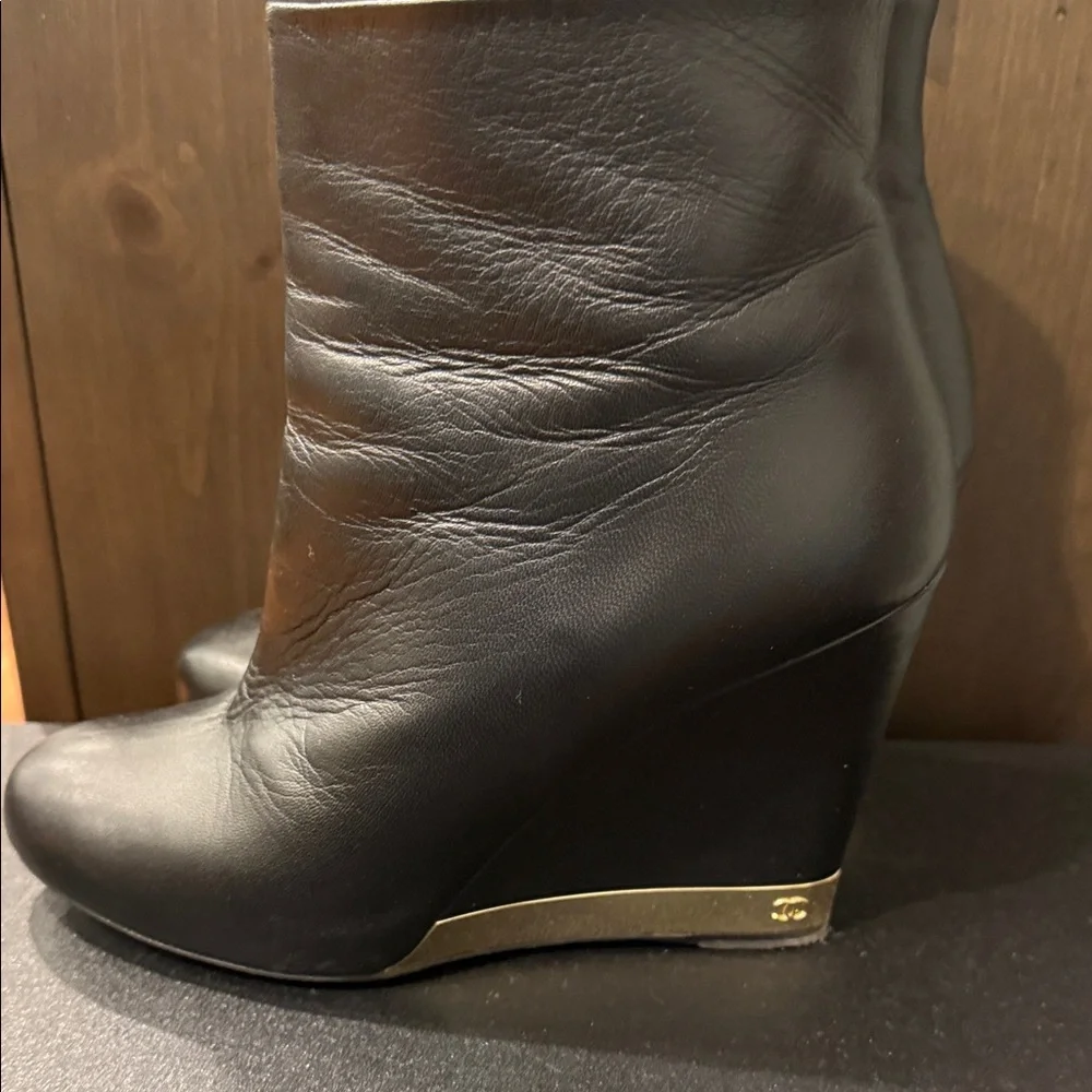 CHANEL Black Leather Wedge Boots with Gold Accent